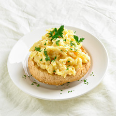 Scrambled eggs on bun