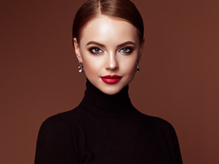 Beautiful Young Woman with Clean Fresh Skin. Perfect Makeup. Beauty Fashion. Red Lips. Cosmetic Eyeshadow. Smooth Hair. Girl in Black Turtleneck