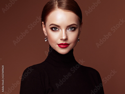 Beautiful Young Woman with Clean Fresh Skin. Perfect Makeup. Beauty Fashion. Red Lips. Cosmetic Eyeshadow. Smooth Hair. Girl in Black Turtleneck