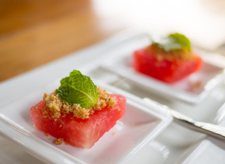 Fried Dried Fish with red watermelon on white dessert plate