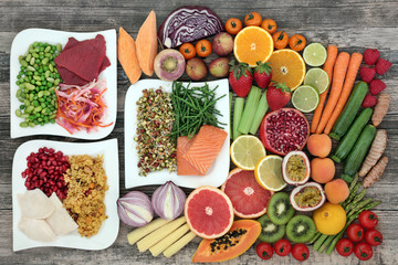 Diet health food concept with a large variety of vegetables, fruit, meat, fish, grain salad and spice with foods high in  protein, antioxidants, dietary fibre, anthocaynins and vitamins. Top view.