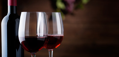 Red wine. Wine. Bottle and glasses of Red wine with ripe grapes.