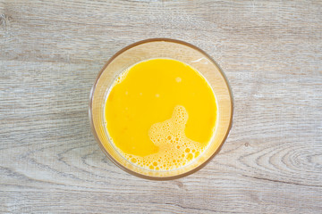 Egg yolk in bowl on table 
