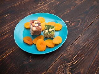 Natural Eastern sweets rahatlukum and dried apricots on a beautiful plate