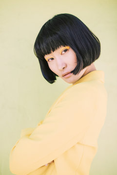 Portrait Of Young Woman Posing In Yellow Blazer