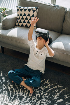 Boy wearing virtual glasses at home