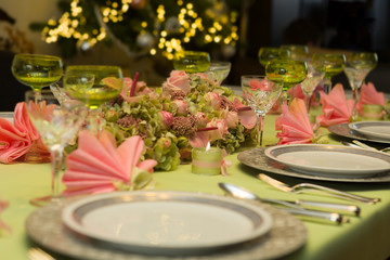 Obraz na płótnie Canvas Christmas dinner table in pink and green