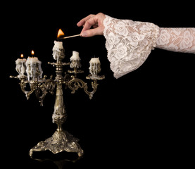 Vintage hand lighting candles