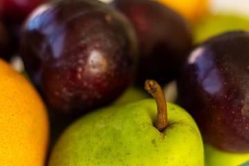 Detail of a fresh pear and plums