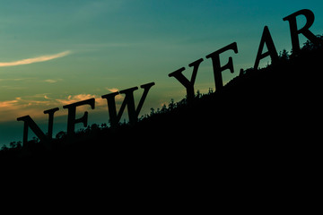 new year silhouette text on mountain background