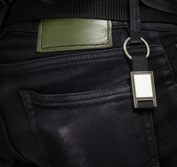 Steel key ring hanging on black jeans. Blank key chain for your design. Souvenir or accessory. Can...