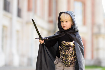 Portrait of a cute little boy dressed as a medieval knight