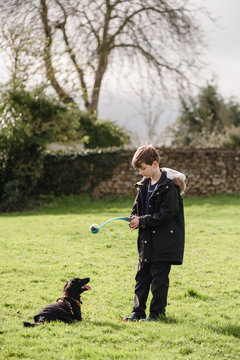 Boy playing fetch with his dog