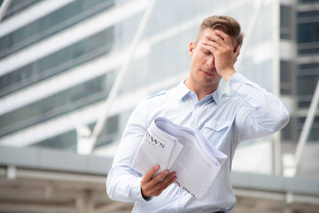 Business people reading newspaper outdoor