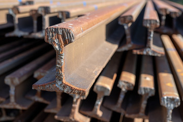 Railway tracks stored at the railway station. The place of cutting rails with a gas burner.