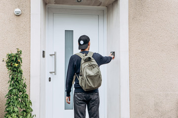 The tourist rings the doorbell to check in to the room he has booked or the student with the backpack returns home after classes at the institute or on vacation.