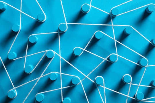 Blue pins connected by white string.