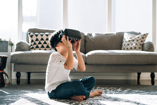 Boy wearing virtual glasses at home