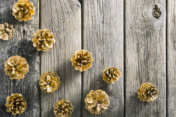 golden pine cones Christmas decoration on old wood table background