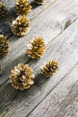 golden pine cones Christmas decoration on old wood table background