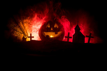 Scary view of zombies at cemetery dead tree, moon, church and spooky cloudy sky with fog, Horror...