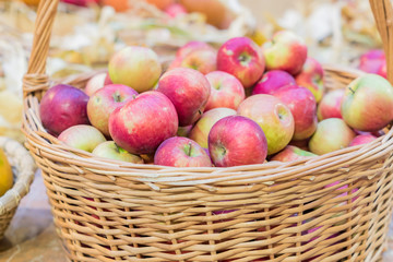 close up of red ripe apples in a basket at the farmer's market