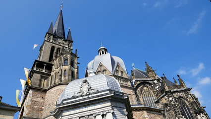 Türme und Kuppeln des Aachener Domes ragen in den blauen Himmel