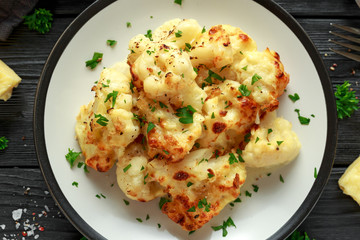 Roasted cauliflower with cheddar cheese sauce and herbs.