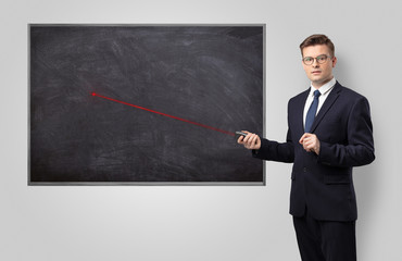 Handsome young teacher with laser pointer teaching 
