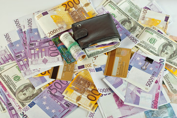 Lots of money on the table. Currency of different countries and a penny on a white background.