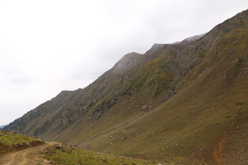 Mountains in kashmir under cloudy sky 