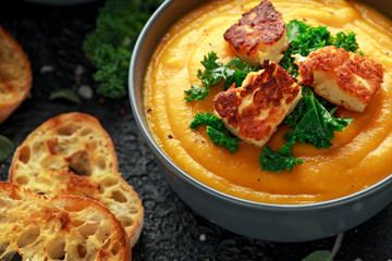 Baked butternut squash and carrot cream soup with steamed kale and fried halluomi