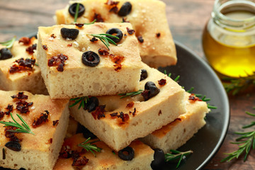 Homemade Italian focaccia with sun dried tomatoes, black olives and rosemary