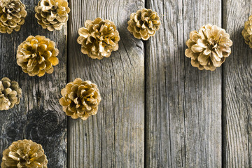 golden pine cones Christmas decoration on old wood table background