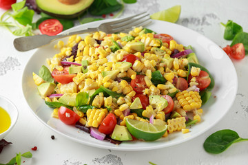 Sweet Corn salad with tomatoes, avocado, red onion, herbs and lime