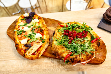Pie or cake with arugula and red currant is on the Board