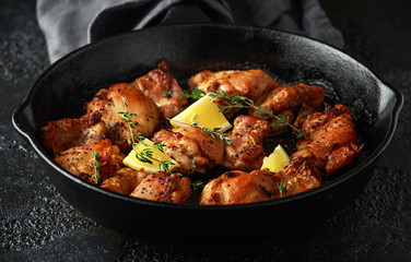Roasted boneless skinless chicken thighs in lemon and thyme dressing served in vintage cast iron...