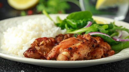 Roasted boneless skinless chicken thighs with rice and green vegetables mix