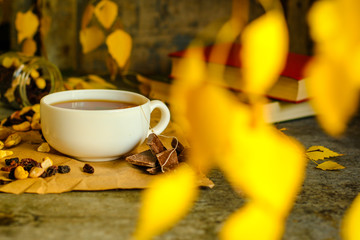 Tea - a cup of tea is brewed tea bag. cup on the table and yellow leaves. top view.