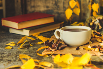 Tea - a cup of tea is brewed tea bag. cup on the table and yellow leaves. top view.