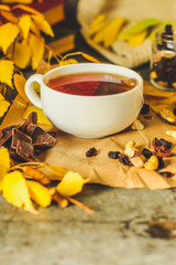 Tea - a cup of tea is brewed tea bag. cup on the table and yellow leaves. top view.