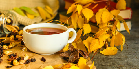 Tea - a cup of tea is brewed tea bag. cup on the table and yellow leaves. top view.