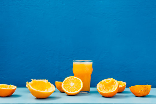Orange juice on blue background
