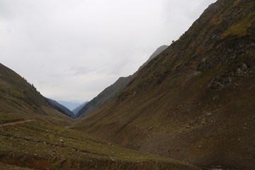 Beautiful Tracks on big mountains in kashmir under cloudy sky 