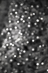 New Year's background a bokeh from sparks illumination on a fir-tree white and silver color