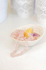 Healing crystals and gemstones on a white table: Amethyst Point, Citrine, Calcite and rose quartz are bringing positive energy to support inner strength
