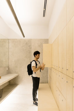 Man arranging stuff in cloakroom