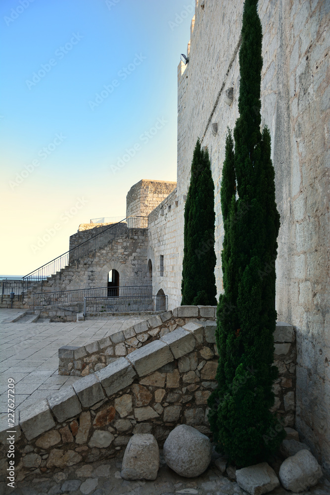 Poster Exterior building close up of Peniscola Castle  , Costa del Azahar, province of Castellon, Valencian Community. Peniscola is a popular tourist destination in Spain.