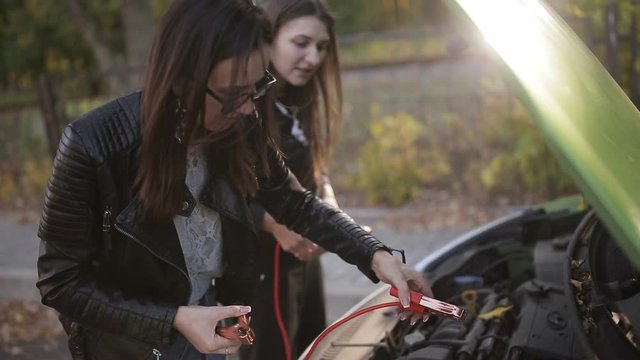 Jump Starting a car, detail footage of cables charging a dead battery