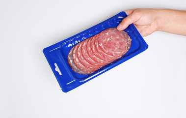 blue vacuum packing sausage cut hold hand